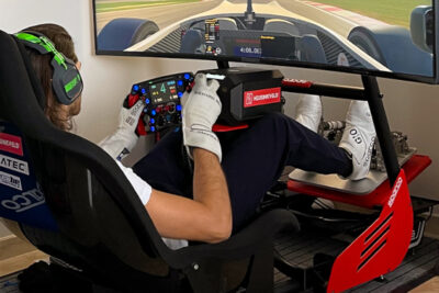 A clickable image of a driver in a sim racing set up