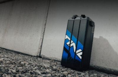 Close-up of a racing helmet storage box with Grand Prix Racewear branding, designed for motorsport safety gear.