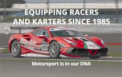 Red and white race car on track with Grand Prix Racewear branding, high-speed motorsport vehicle.