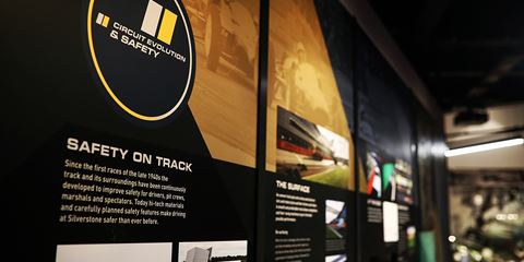 Exhibition display about safety on track at Grand Prix Racewear, featuring information panels and safety equipment.