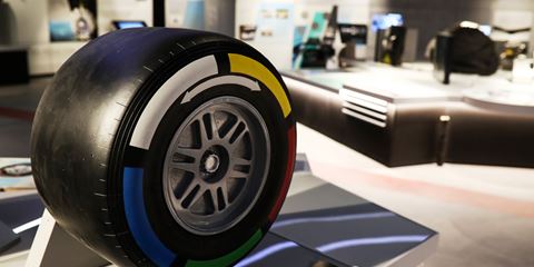 Close-up of a racing tyre with coloured markings at a Grand Prix Racewear display.