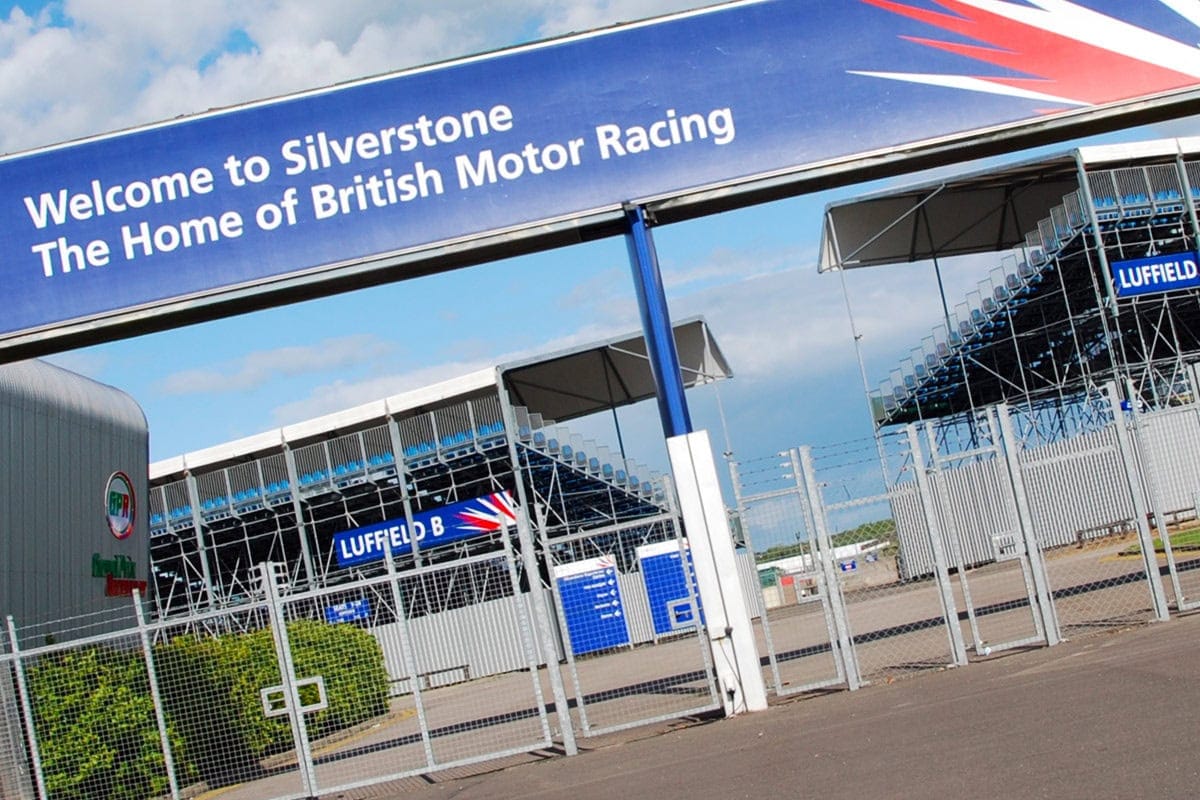 Entrance to Silverstone Circuit with signage welcoming visitors to the home of British motor racing.