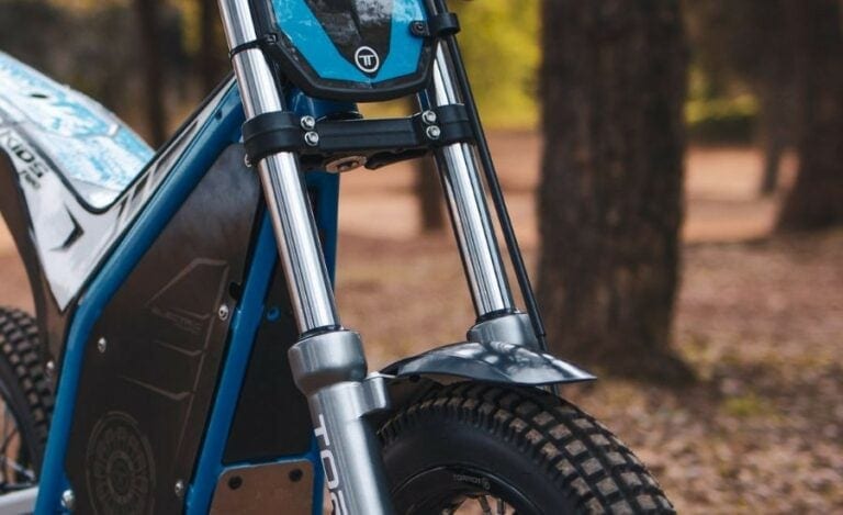 Close-up of a mountain bike with purple frame and thick tires, suitable for off-road cycling.