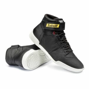 Black Sabelt racing shoes with white soles designed for motorsport safety and performance.