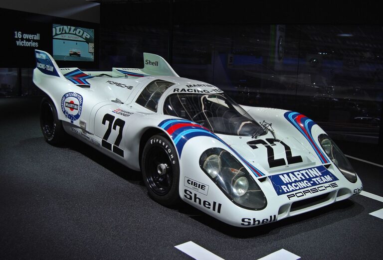 Classic Martini Racing Porsche 917 race car with iconic livery and number 22, displayed at an exhibition.