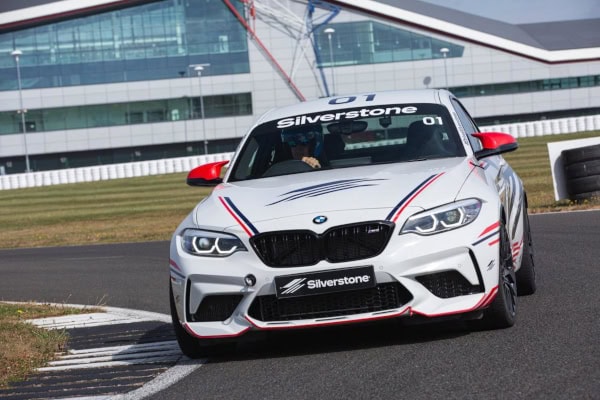 High-performance BMW race car with Silverstone branding on a race track, ready for motorsport events.