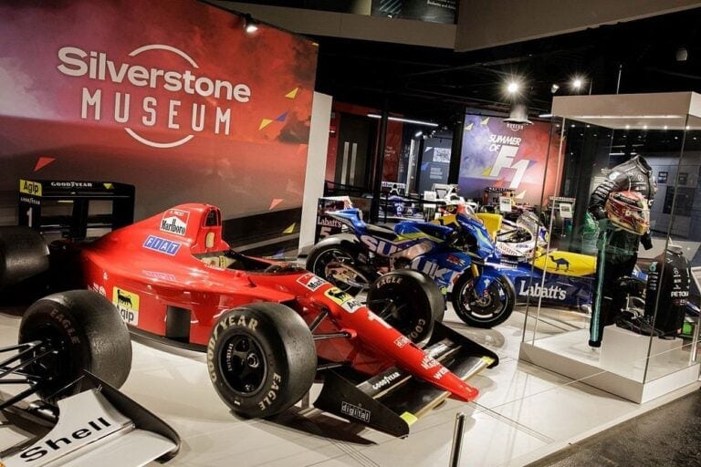 Exhibition of vintage and modern Formula 1 cars at Silverstone Heritage Museum, showcasing racing history and memorabilia.