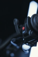 Close-up of motorcycle handlebar with throttle and control switch, highlighting high-quality racing equipment.