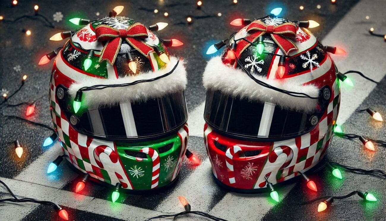 Two racing helmets decorated with Christmas lights and festive ribbons, celebrating holiday spirit and motorsport style.