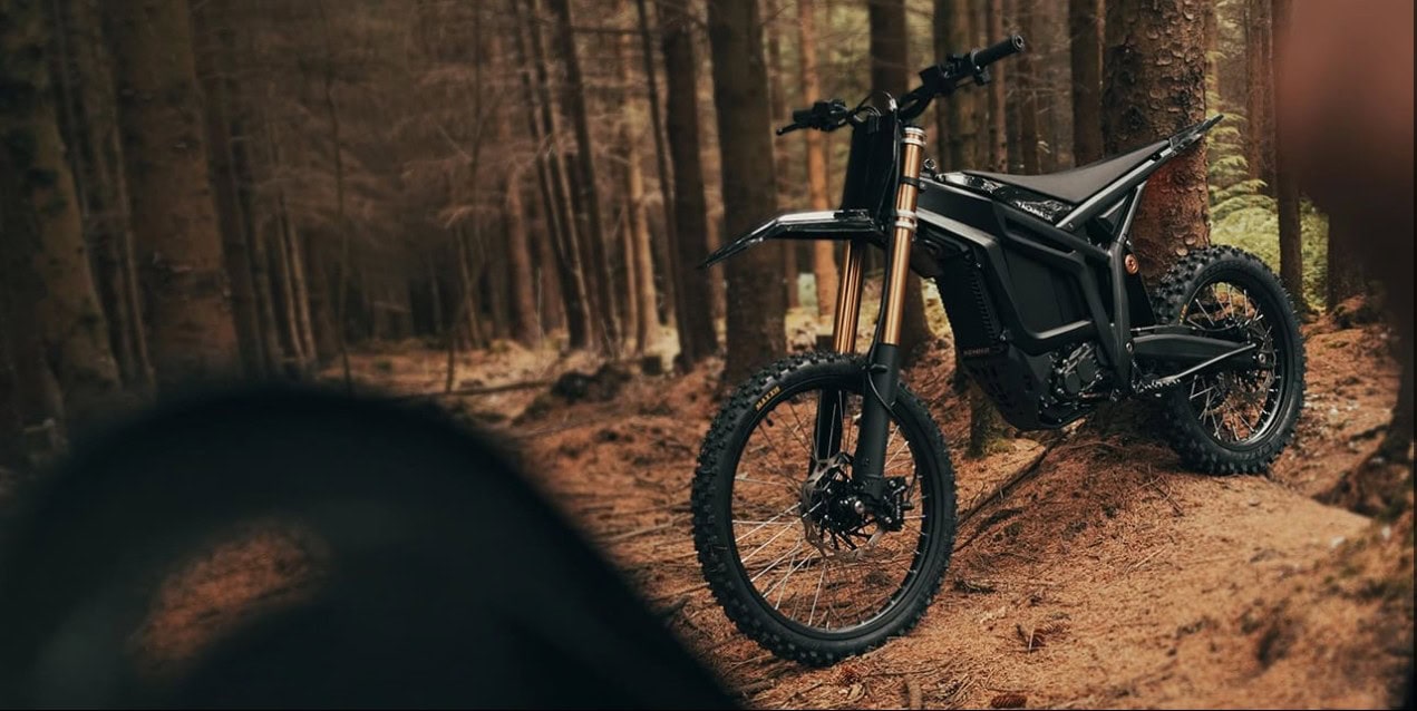Electric mountain bike in a forest setting, showcasing off-road capabilities and modern design.