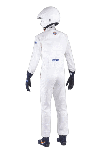 Professional racing driver in white Grand Prix Racewear suit with helmet, gloves, and racing shoes, ready for motorsport competition.