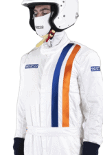 Professional racing driver in white Grand Prix Racewear with blue and orange stripes, wearing a helmet and gloves, ready for motorsport competition.