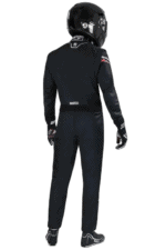 Professional racing driver in Grand Prix Racewear with helmet, suit, and gloves, ready for motorsport competition.
