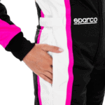 Close-up of a racing driver wearing Grand Prix Racewear with a black, white, and pink racing suit featuring the Sparco logo.