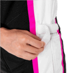 Close-up of a person adjusting a white racing suit with pink and black accents, highlighting racewear details.