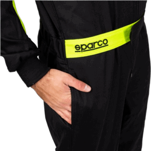 Close-up of a person wearing a black racing suit with a yellow Sparco belt, highlighting professional motorsport apparel.