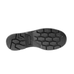 Close-up of a black racing shoe sole with hexagonal grip pattern for motorsport safety and performance.