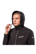 Male model wearing black Grand Prix Racewear jacket with hood, featuring Alpinestars logo, for motorsport safety and performance.