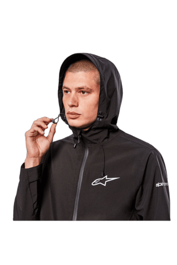 Male model wearing black Grand Prix Racewear jacket with hood, featuring Alpinestars logo, for motorsport safety and performance.