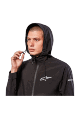 Male model wearing black Alpinestars racing jacket with hood, close-up shot for Grand Prix Racewear.