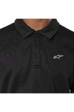 Close-up of a black Alpinestars polo shirt with a white logo on the chest, designed for motorsport enthusiasts.
