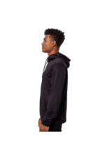 Young man wearing a black Grand Prix Racewear hoodie, standing in profile against a plain background.
