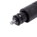 Close-up of a black motorcycle shock absorber with a threaded bolt, used in Grand Prix racewear for high-performance racing bikes.