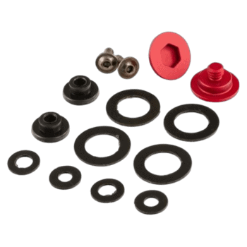 Set of racing car suspension parts including rubber washers, metal balls, and red plastic components for Grand Prix racewear.