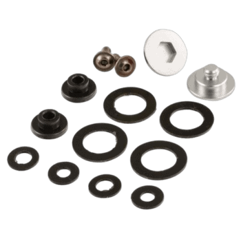 Set of black rubber washers, metal nuts, and a white plastic component for Grand Prix racewear maintenance and assembly.