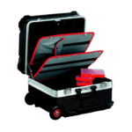 Open black racing equipment case with red-lined compartments and pink boxes inside, suitable for Grand Prix racewear storage.