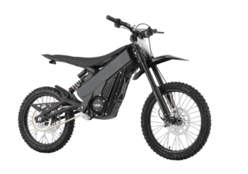 Electric dirt bike with black frame and knobby tires, designed for off-road riding and motocross.