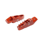 Red Grand Prix racing footpegs with metal spikes for motorcycle racing, designed for grip and stability.
