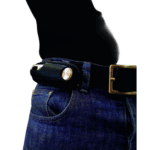 Close-up of a person wearing a black belt with a silver buckle and a black holster attached to the belt, set against a plain background.