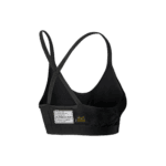 Black racing harness with safety labels, designed for motorsport safety gear from Grand Prix Racewear.