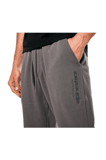 Close-up of a person wearing grey Spinestrars racing joggers with side pocket, suitable for motorsport enthusiasts.