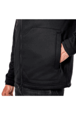 Close-up of a person wearing a black Grand Prix Racewear jacket with a front pocket, suitable for motorsport enthusiasts.