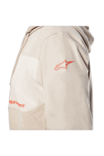 Close-up of a beige racing hoodie with Alpinestars logo on the shoulder, designed for motorsport enthusiasts and racers.
