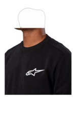 Close-up of a person wearing a black Grand Prix Racewear sweatshirt with Alpinestars logo, focusing on racing apparel for motorsport enthusiasts.