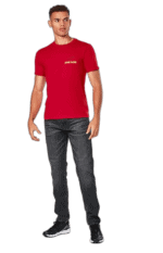 Young man wearing a red Grand Prix Racewear T-shirt and dark jeans, standing confidently against a plain background.