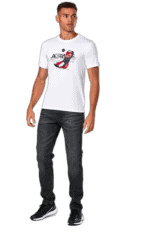 Young man wearing a white Grand Prix Racewear t-shirt with racing shoe graphic, standing confidently against a plain background.