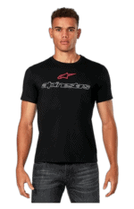 Young man wearing a black Alpinestars T-shirt with logo, standing against a plain background.