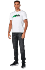 Young man wearing a white Grand Prix Racewear T-shirt with green and black logo, standing confidently against a plain background.