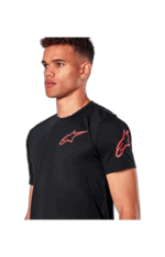 Male model wearing black Grand Prix Racewear T-shirt with Alpinestars logo, suitable for motorsport enthusiasts and racers.