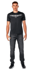Young man wearing black Astars racing t-shirt and jeans, standing confidently for Grand Prix Racewear.