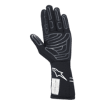 Black racing glove with grey and white accents, designed for motorsport safety and performance, featuring the Alpinestars logo.
