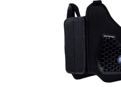 Close-up of a black Grand Prix Racewear racing mask with honeycomb ventilation and adjustable strap for motorsport safety.