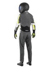 Professional racing driver in Grand Prix Racewear suit with helmet, gloves, and racing shoes, ready for motorsport competition.