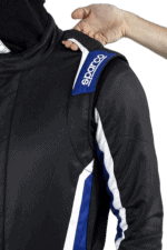 Close-up of a racing suit with Sparco branding, highlighting high-quality racing apparel for motorsport enthusiasts.