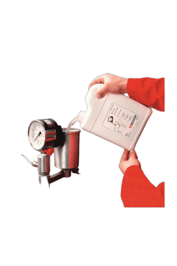 Person in red jacket pouring liquid into a pressure gauge testing device for Grand Prix Racewear safety gear.