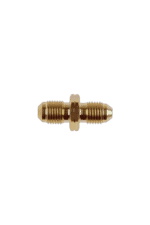 Close-up of a small brass fitting or connector used in racing car fuel or oil systems, highlighting precision engineering.